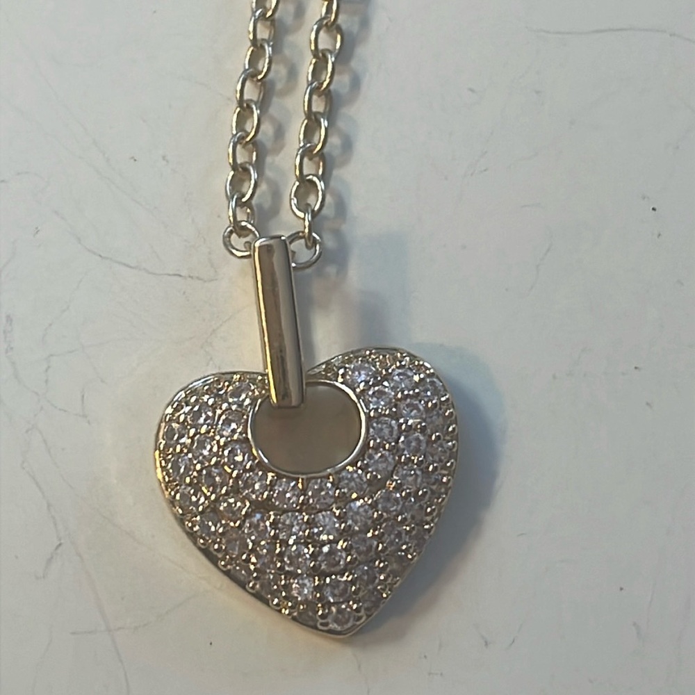 Heart necklace maker unknown.
Crystals on heart set in 14k Yellow Gold Plate